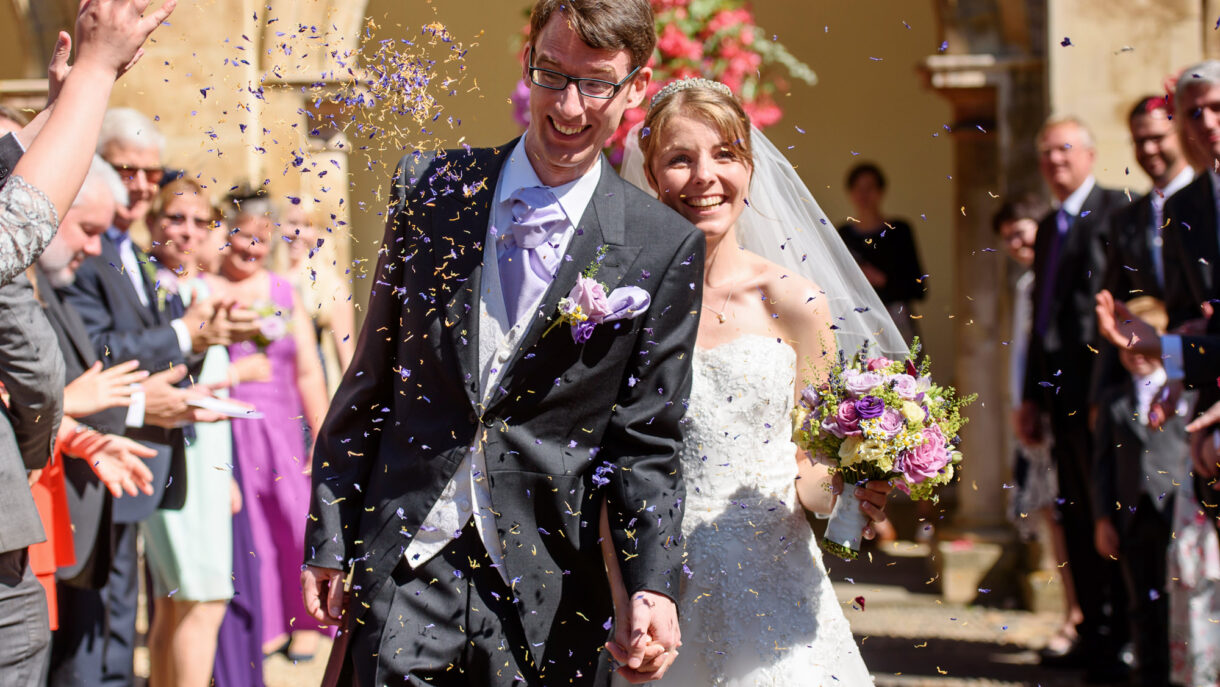 bride and groom showered in confetti