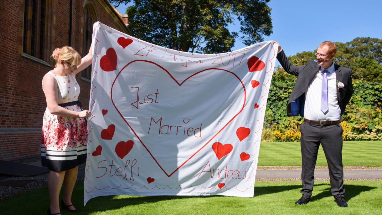 guests holding sign just married