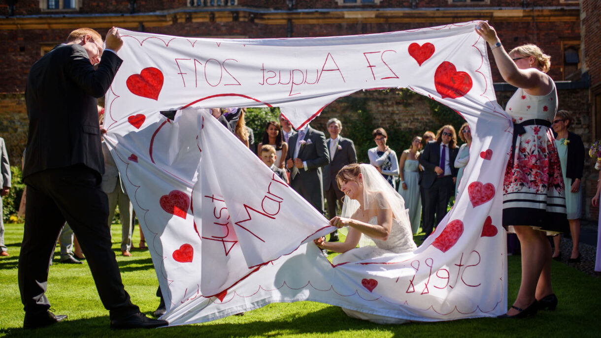 bride cutting out heart shape from a huge sheet
