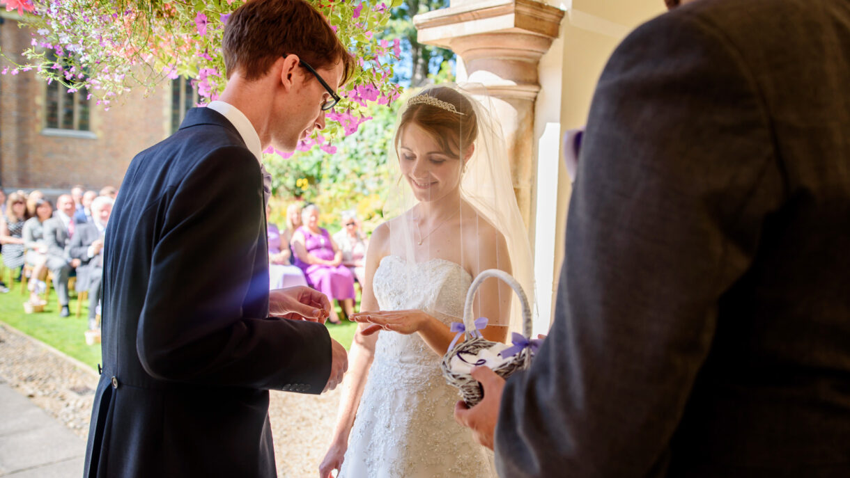 bride and groom exchanging rings during ceremony